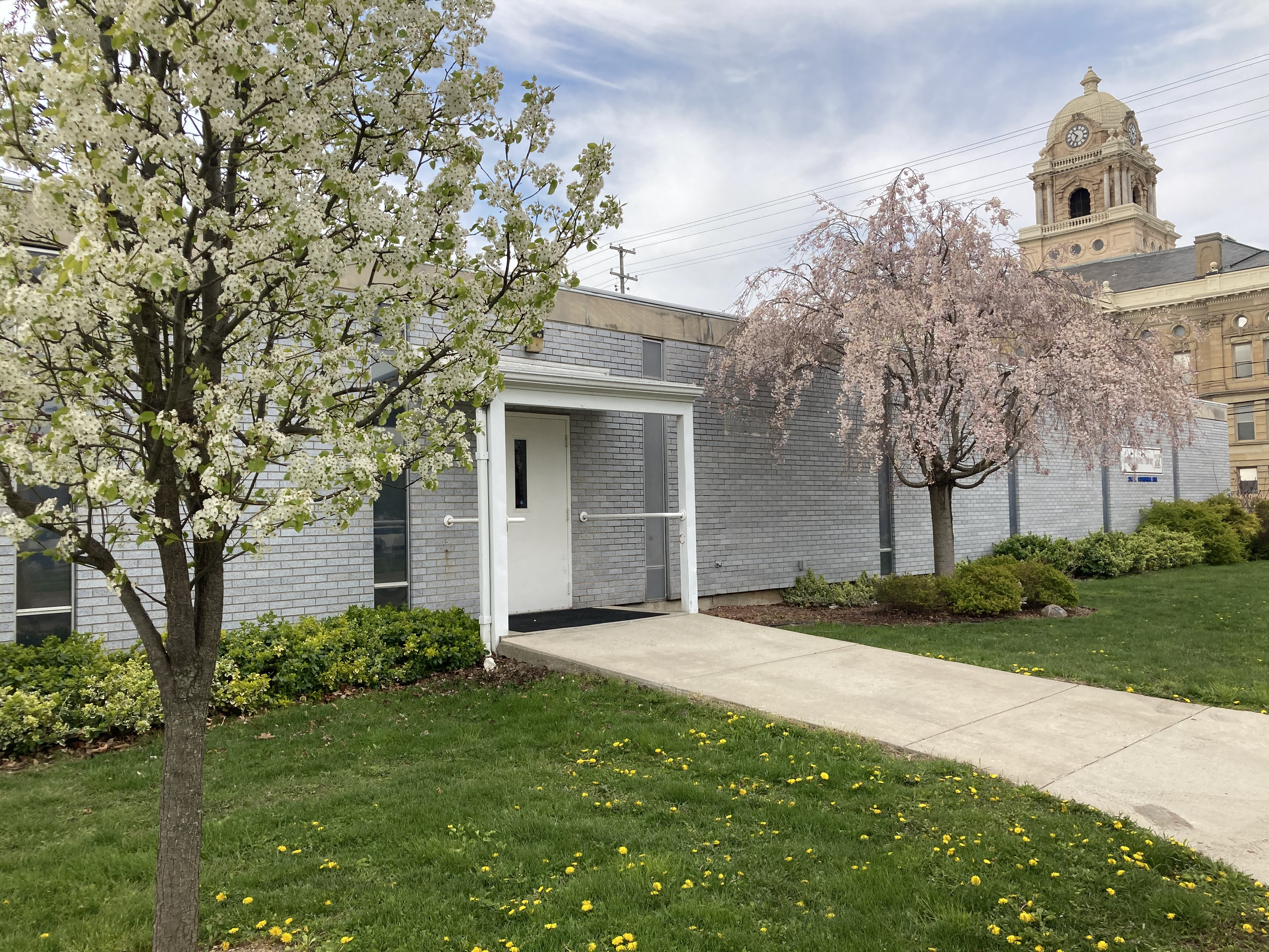 Administrative Office door with flowering trees and court house in the background