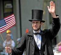 Abraham Lincoln in hat with American flag in hand