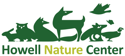 Green lettering Howell Nature Center with animal outlines.