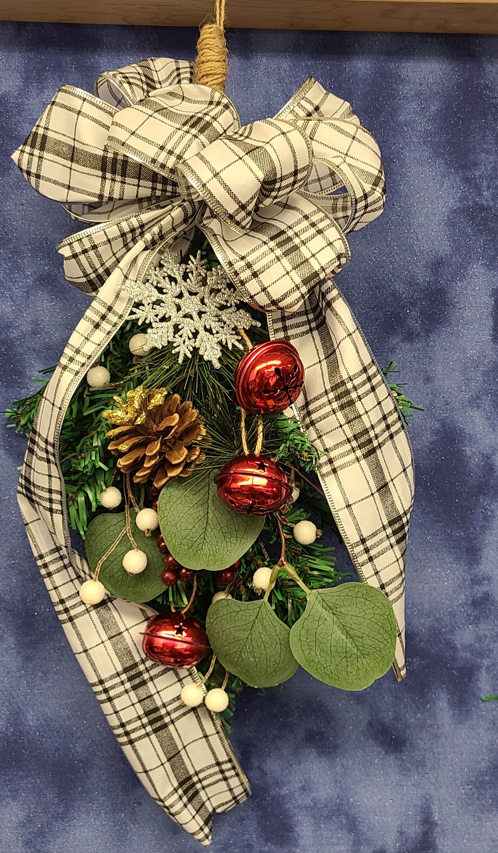 red checked Christmas ribbon with greens and red berries