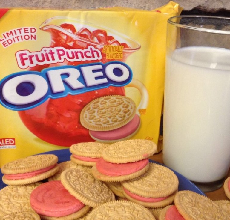 pink filled Oreo cookies and glass of white milk