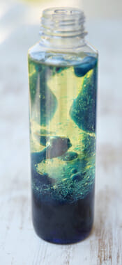 clear bottle with green and yellow colors, lava lamp