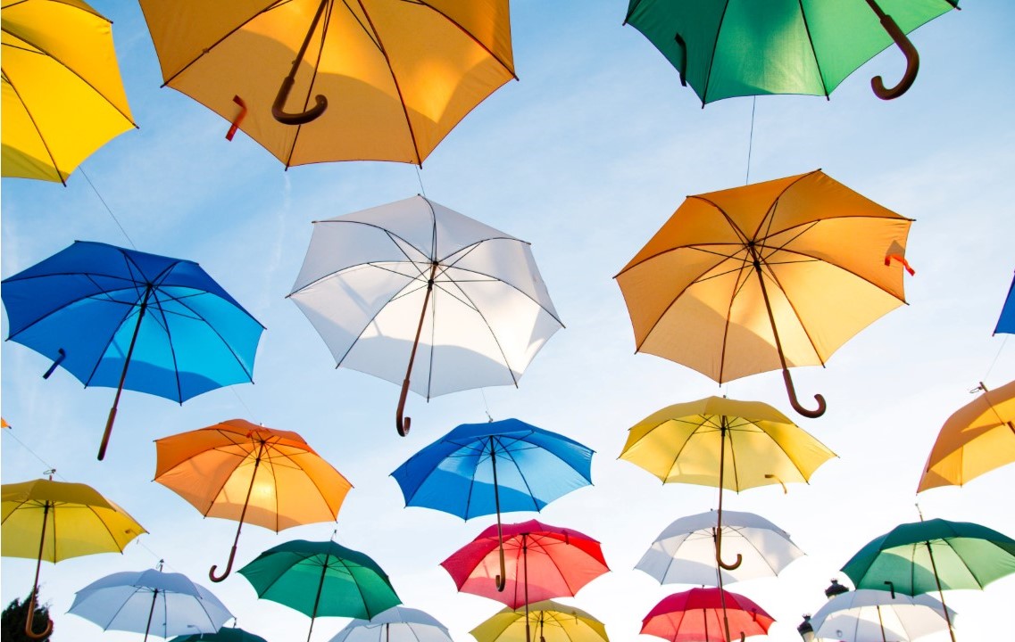 multi colored umbrellas with blue sky