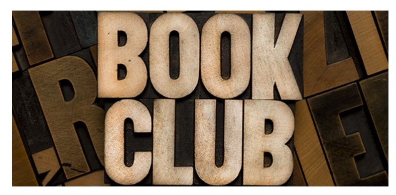 Brown and white sign spelling, book club