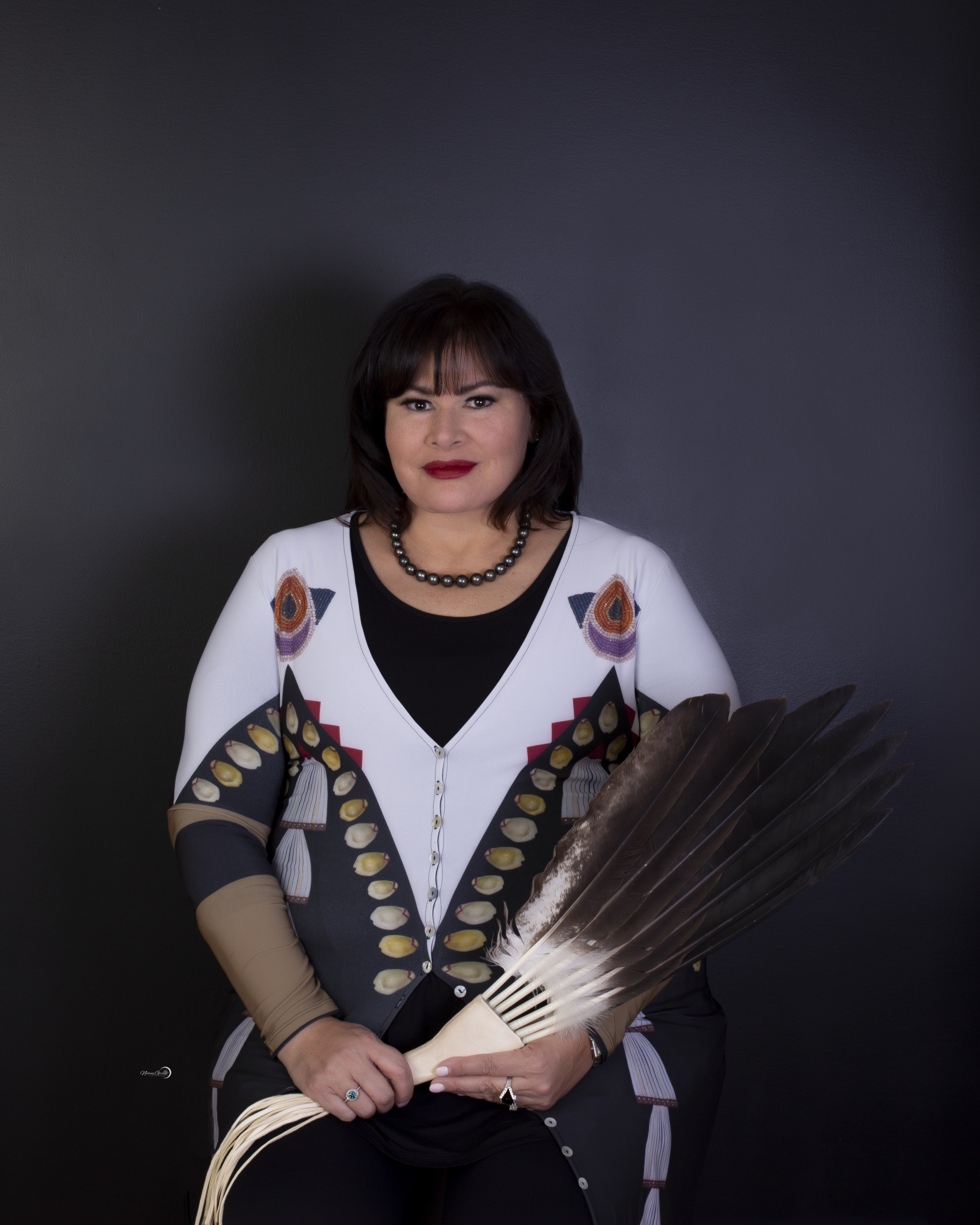 woman with black hair and Indigenous dress