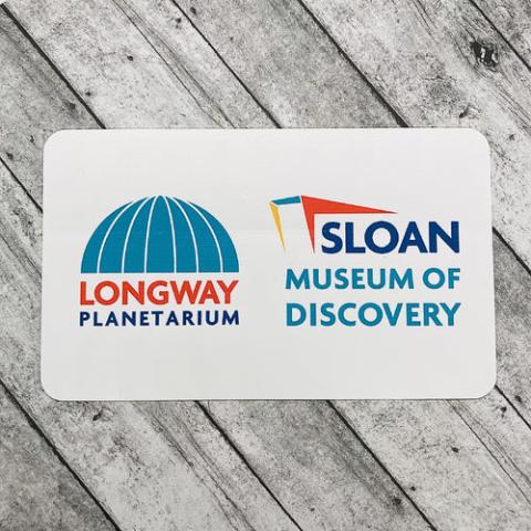 teal, red, blue, and white sign for Sloan Museum of Discovery