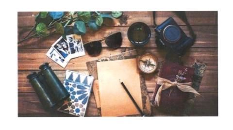 photo of binoculars, cards, sunglasses, writing paper and pencil