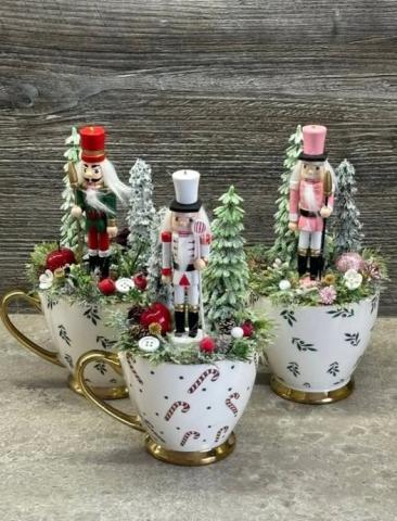 mugs with nutcracker decorations on top