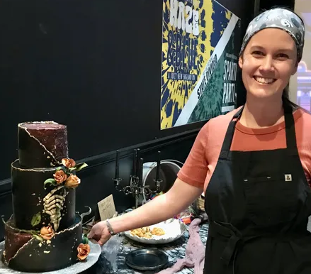 baker with wedding cake