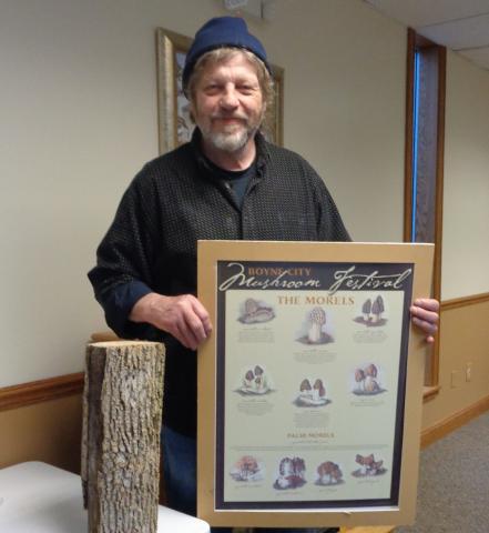 Man holding poster of mushrooms