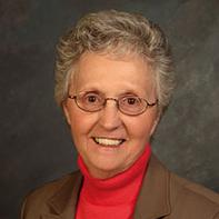 photo of lady wearing glasses and red blouse