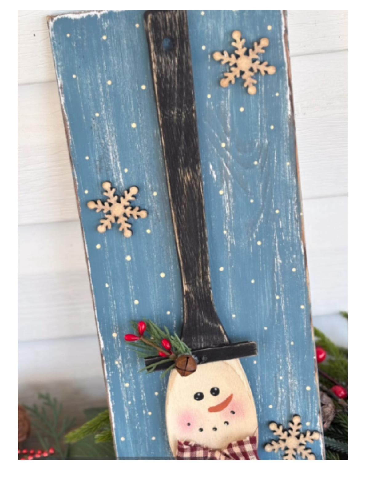 wooden board with snowman made from spoon