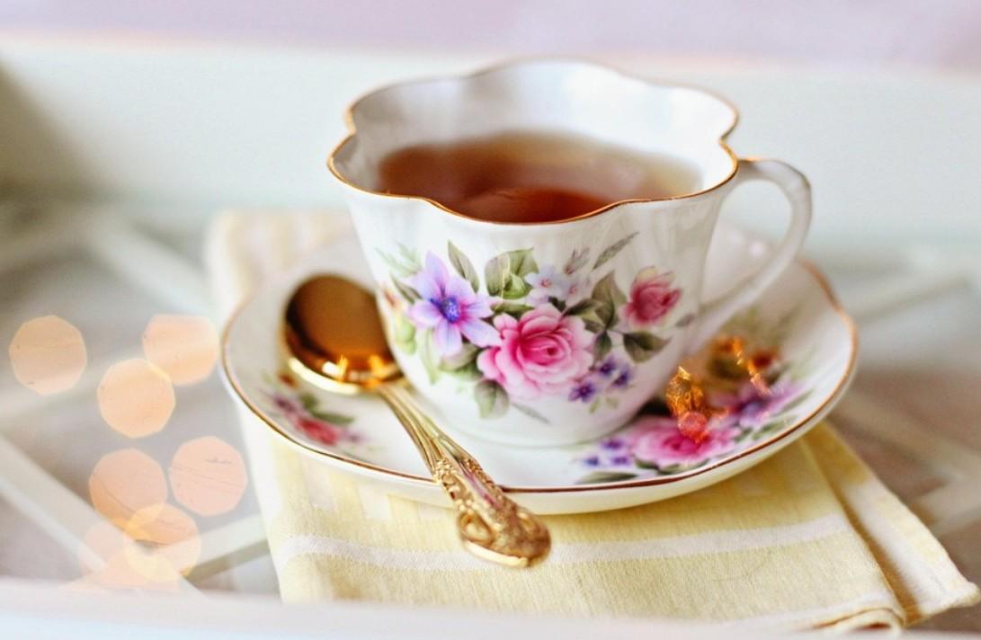 floral tea cup and gold spoon